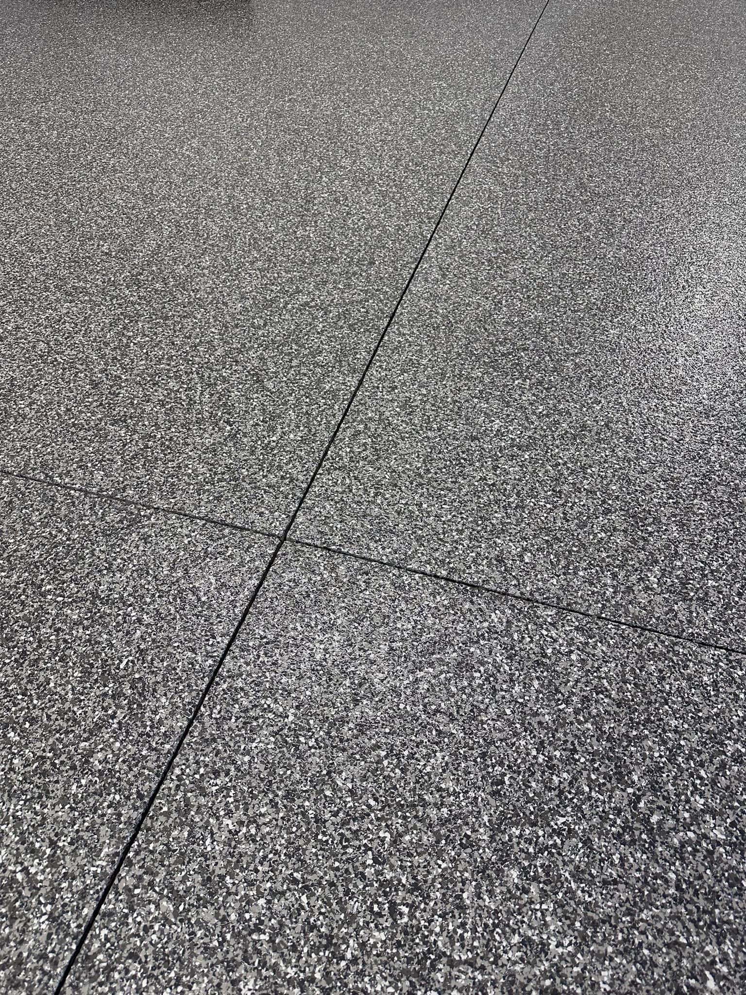 Close-up of a charcoal and silver full-flake epoxy garage floor with gloss topcoat, Central New York