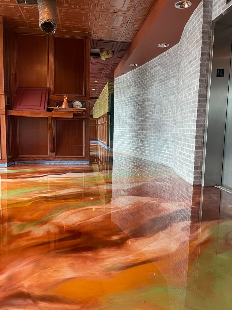 Glossy copper metallic floor in a restaurant dining room — Central New York