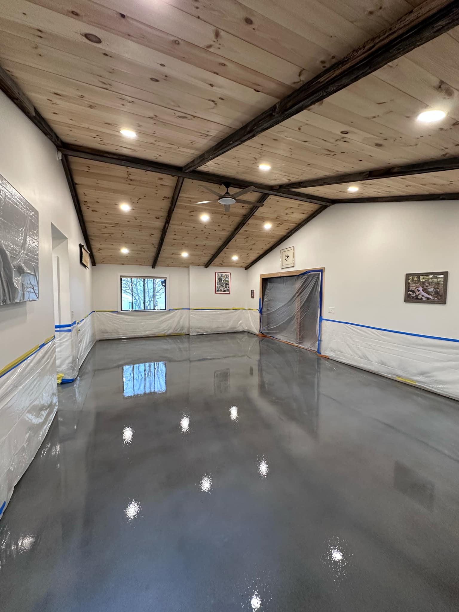 Glossy solid gray metallic floor in a large finished room, Central New York